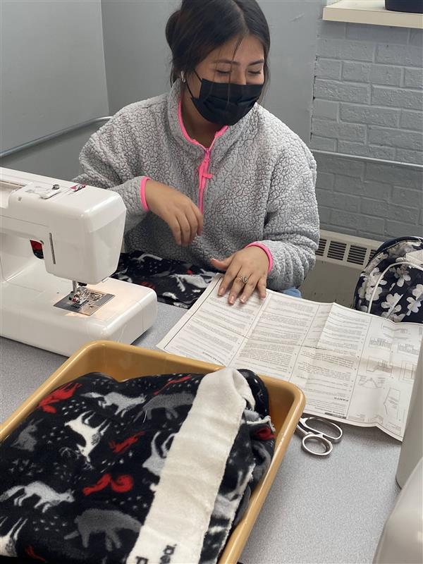 Student sewing a garment.