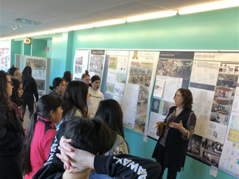 Students looking at sample interior design boards.